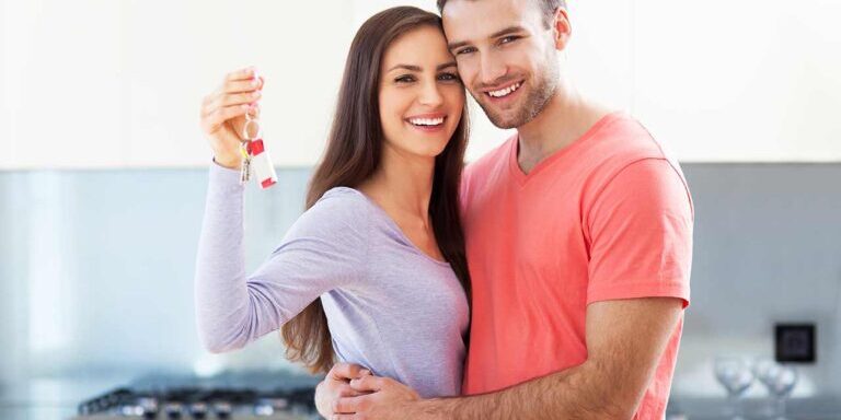 happy couple owning a house